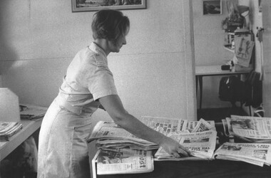 A photograph Red Cross Member Rosemary Griggs organises the Red Cross hut for the day of patient and general visitors. 