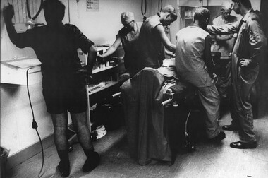 A photograph of Triage in the 1st Australian Field Hospital, preparing a "Dustoff" wounded Digger prior to going to theatre. 