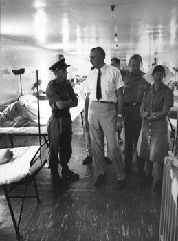 A photo Commanding Officer at the 1st Australian Field Hospital, Lt Col Hurley escorts the Leader of the Opposition Mr Gough Whitlam. 