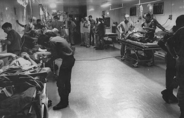 A photo of triage with all six bays working, at the 1st Australian Field Hospital  with 2 VietCong and four wounded diggers being assessed.