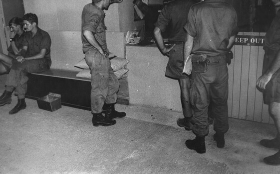 A photograph of Nursing Sister Capt Shirley Southwell answers the telephone as she mans the regimental aid post the 1st Australian Field Hospital.