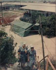 A photo of Capt Amy Pittendreigh and  Lt Terrie Roche, Lt Colleen Mealey and  Lt Margaret Ahern, climb the long stairway to the Officers Mess.