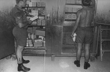 A photo of a Cpl Medic makes notes as his assistant checks the fluids and injections in one of the 1st Australian Field Hospital. 