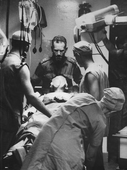  Lt Col Ian Miller with Sr Fay Lewis and Medics in triage at the 1st Australian Field Hospital prepare a Digger for surgery. 