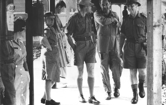 A photo at 1st Australian Field Hospital, Army personnel, including the CO of the hospital hand Medivac Diggers to the care of RAAF personnel. 