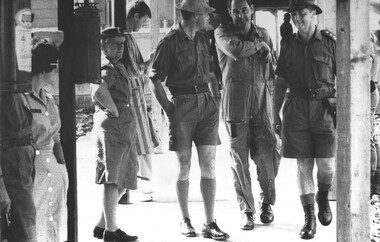 A photograph at 1st Australian Field Hospital, Army personnel, including the CO of the hospital hand Medivac Diggers to the care of RAAF personnel for the flight home.  