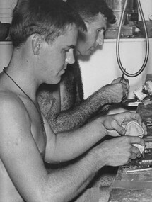 A photograph at the 1st Australian Field Hospital, Dental Technicians engrossed in the work as they manufacture false teeth in their well equiped workshop.