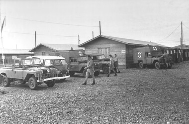 A photograph of 1st Australian Field Hospital, Diggers responsible for transport carry out daily maintenance on the fleet of hospital ambulances. 