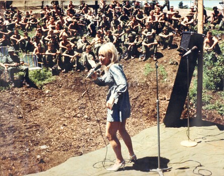 A photograph Beverly Braidwood from the South Australian Concert Party entertains the Diggers at the1st Australian Logistics Base, Vung Tau. 