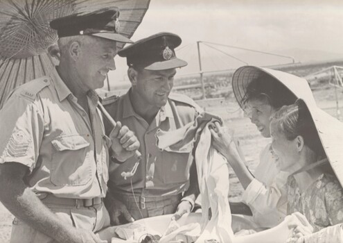 A photograph taken at Phang Rang, Flt Sgt Al Thomas and Sgt Ray Morrison of 2 Sqn RAAF shelter from the midday sun. 