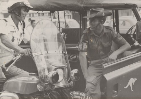 A photograph taken at Saigon of 1967. Cpl Mal Hatch a member of the Provost Detachment at Australian HQ talks with a Vietnamese policeman.