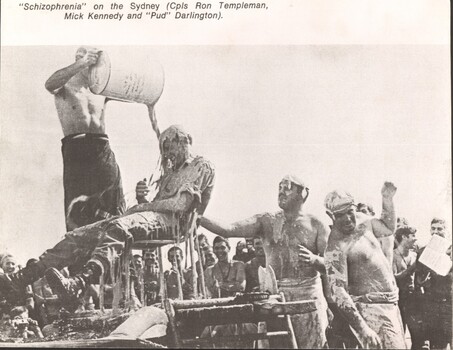 A photograph of Schizophrenia on HMAS Sydney. A digger is given a shower during the "crossing of the line" ceremony.  