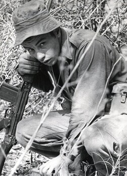 A photograph of a NZ infantry soldier Pte Growden a member of 4 RAR/NZ sets up a claymore mine ambush. 