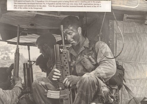 A photograph of SAS patrol onboard a 9 Sqn Iroquois helicopter prior to being flown out to a landing pad in the jungle. 