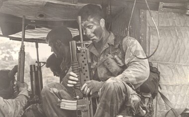 A photograph of SAS patrol onboard a 9 Sqn Iroquois helicopter prior to being flown out to a landing pad in the jungle. 