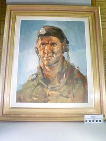 A painting of a tank driver with head phones in a gold frame.