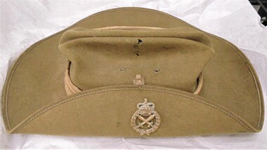 A khaki felt slouch hat issued to Armed Service personnel with a Provost Corps emblem badge.