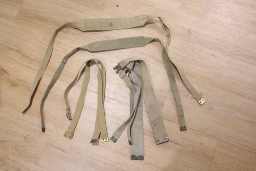 Six pieces of woven strapping that can be connected to each other in various ways with brass fittings.