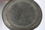 Bottom of pewter mug with makers stamp in metal.