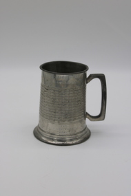 A tankard with an embossed design and personal engraving.