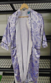 A mauve knee length silk dressing gown.