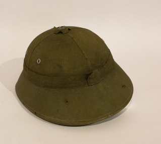 A green North Vietnamese pith helmet issued to the soldiers in Vietnam.