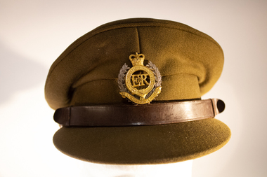 Khaki army peak cap with Royal Australian Engineers Badge in the centre and a leather strap above the peak.