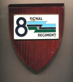 Wooden shield bearing the emblem of 8th Signals Regiment of the Australian Army Reserve.