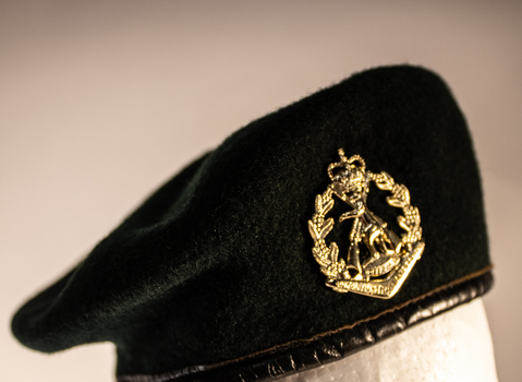 A dark green rifleman's beret with The Royal Australian Regiment badge.