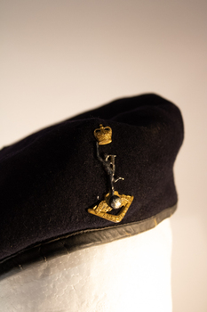 A dark blue navy beret worn by Signal Corp Royal Australian Regiment Servicemen. 