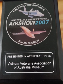 A circular black wooden plaque from the Australian International Airshow 2007.