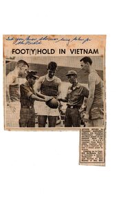 Three aussie soldiers showing two Vietnamese soldiers how an aussie rules football is held.