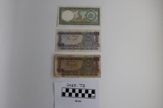 Three notes of Vietnamese money of various values. 