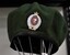 Green beret with NZ infantry badge displayed worn by John T Robinson service number 699302 Royal NZ Infantry, 2nd platoon, Victor 3 company 1968
