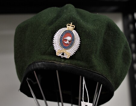Green beret with NZ infantry badge displayed worn by John T Robinson service number 699302 Royal NZ Infantry, 2nd platoon, Victor 3 company 1968