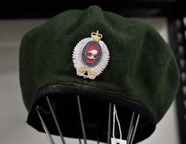 Green beret with NZ infantry badge displayed worn by John T Robinson service number 699302 Royal NZ Infantry, 2nd platoon, Victor 3 company 1968