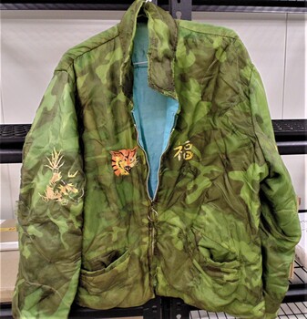 Handmade bomber jacket made from parachute material with embroidery stitching on the back.