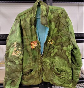 Handmade bomber jacket made from parachute material with embroidery stitching on the back.