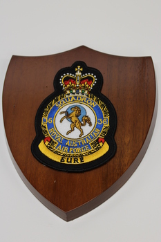 Wooden plaque with a cloth insignia for RAAF Squadron 36.