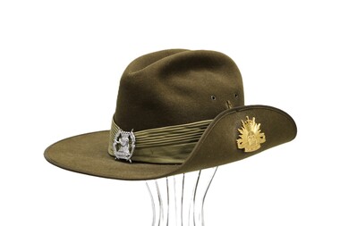 Australian slouch hat with golden Queen's rising sun badge and silver Hunter River Lancers badge.