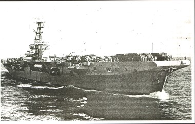 Sepia image of the first transport ship HMAS Sydney June 1965 atsea loaded with troops and trucks.