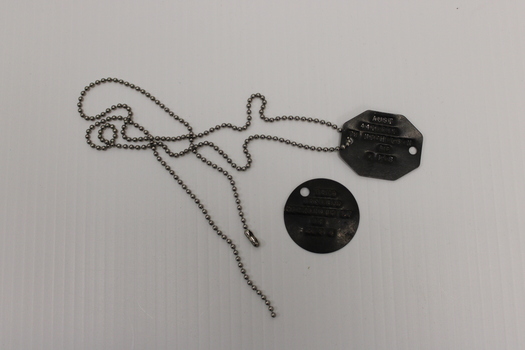 A set of dog tags octagonal in shape issued to T.J. Nicholson 4410261