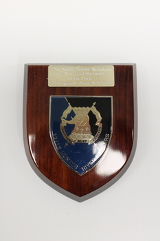 A wooden plaque to WO2 Trevor Nicholson with the insignia of 12/16 Hunter River Lancers 