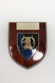 A wooden plaque to WO2 Trevor Nicholson with the insignia of 12/16 Hunter River Lancers 