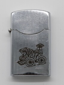 Silver coloured metal cigarette lighter with engraving of a rickshaw and driver.