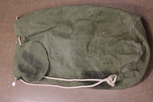 Green duffel bag with  rope handle.