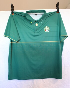 Green polo with 50th Anniversary insignia on left top. Southern cross stitched in white on left collar and yellow star on right collar.