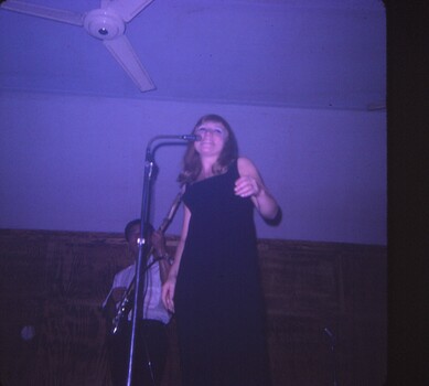 A coloured slide of a female singer and a guitarist named Ben