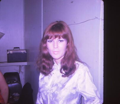 Close up a woman with long hair and a silk jacket.