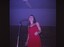 A coloured slide of a singer in a red dress.